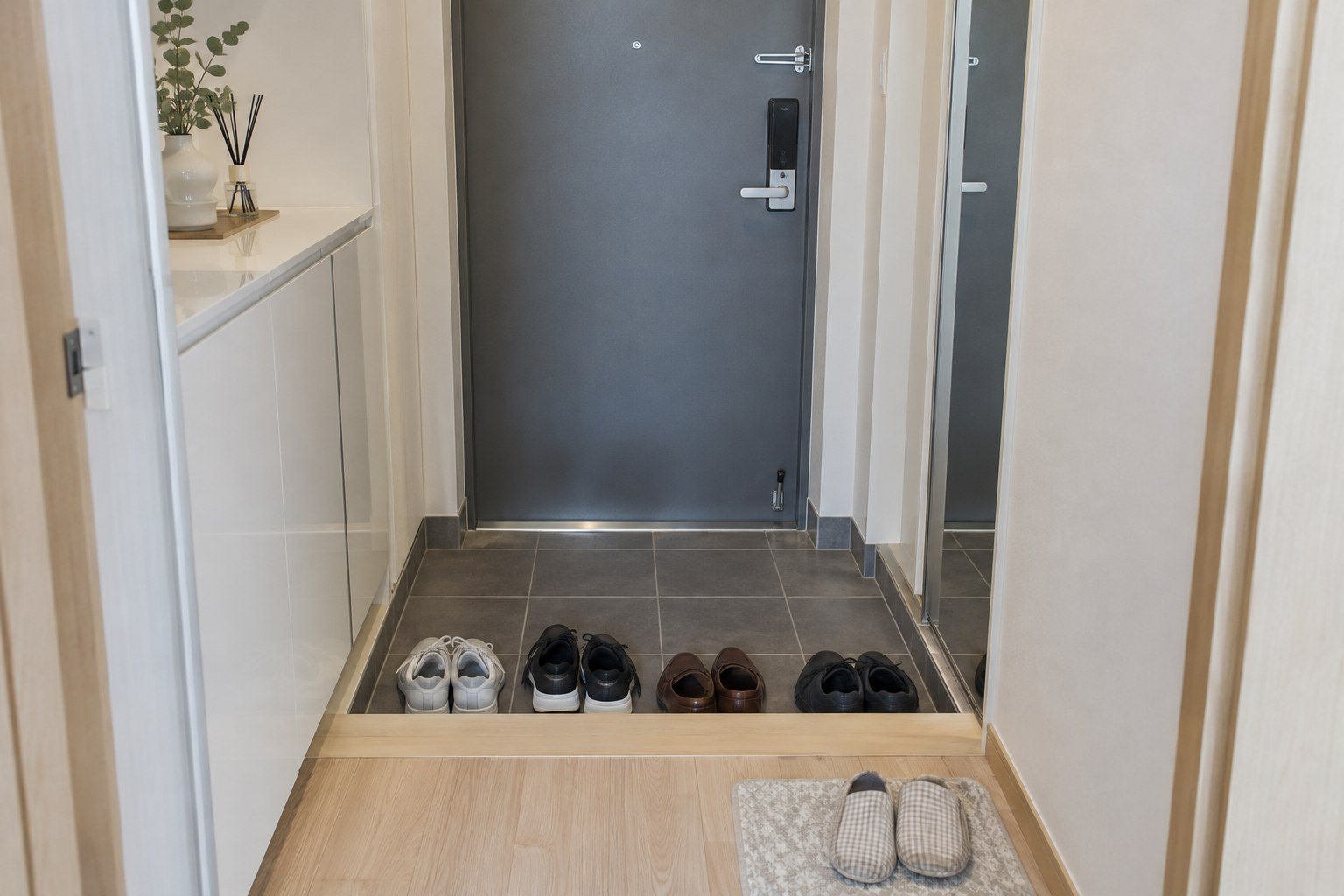 Shoes neatly lined up in the recessed tiled entrance of a modern Korean apartment (AI-generated illustration)